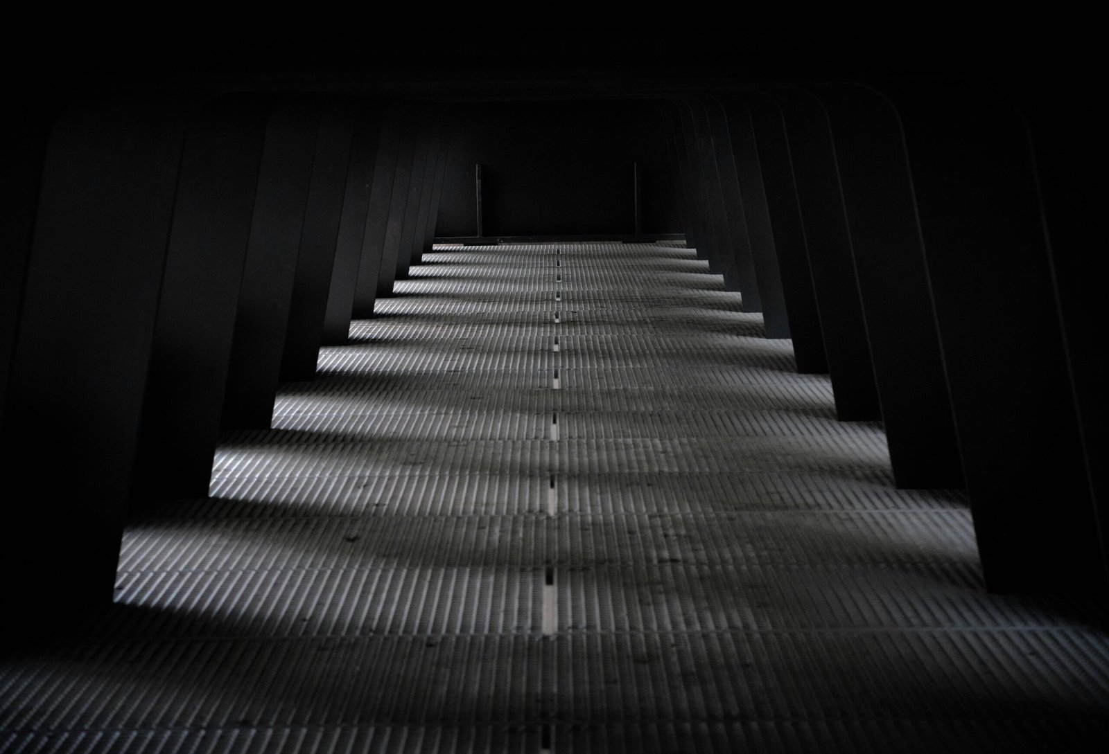 gray and black staircase in a dark room